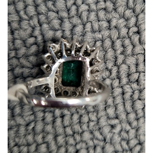 123 - Emerald Diamond cluster ring on white metal shank, ring size M