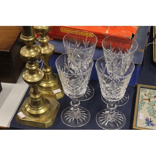 40 - Chinoiserie embroidered panel, 29cm high, four crystal goblets and a pair of brass candlesticks.