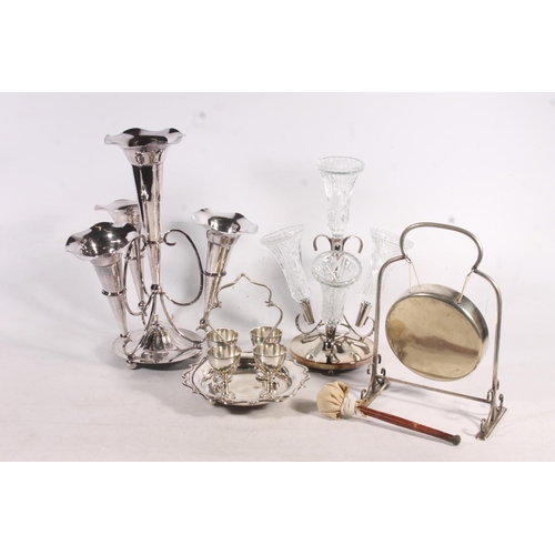 63 - Silver-plated epergne, a dinner gong, a glass and silver-plates epergne and an egg cup set.