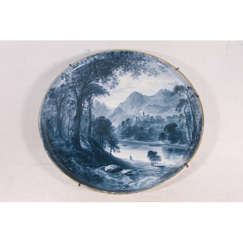 71 - Copeland blue and white charger decorated with landscape scene, signed by William Yale, 45cm wide.