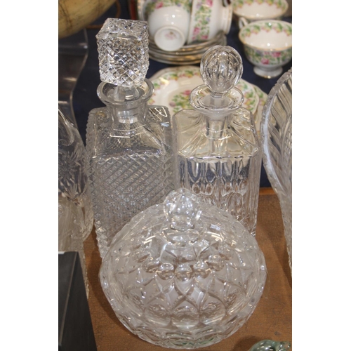 132 - Glass ware to include a bowl, decanters, a paperweight, etc.