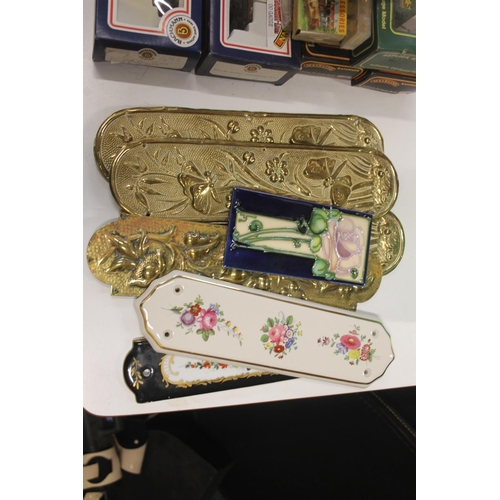 164 - Collection of brass and ceramic finger plates with floral decoration.