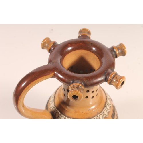 178 - Doulton stoneware puzzle jug, the body with tubelined motto 'Within this jug there is good liquor 'T... 
