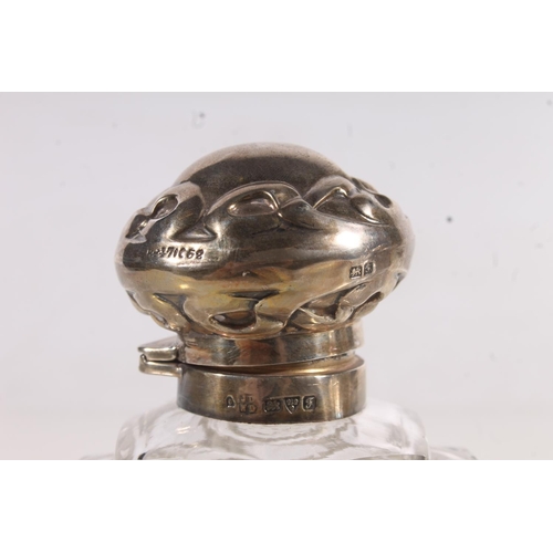 213 - Three hallmarked silver and glass table scent bottles.