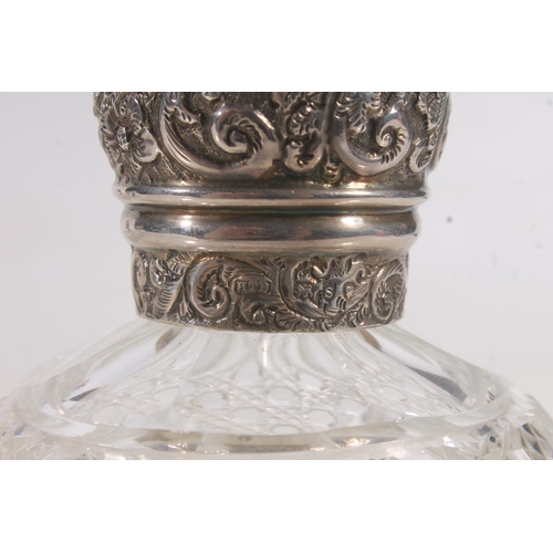 213 - Three hallmarked silver and glass table scent bottles.