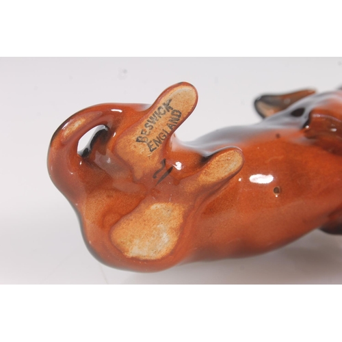 217 - Beswick Dachsund, and four small Royal Doulton figurines (5)