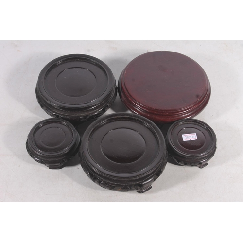 240 - Five Chinese lacquered stands for vases.