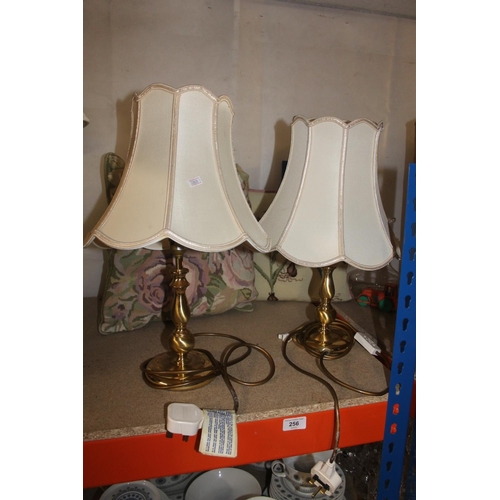 256 - Pair of table lamps and two embroidered cushions.