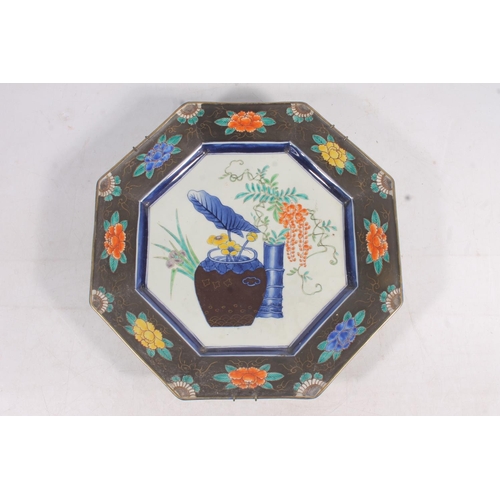 75 - Japanese porcelain octagonal plate, central reserve decorated with vase and flowers, 32cm wide.