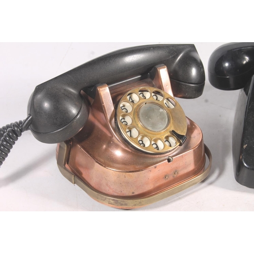 83 - Rtt-56 copper clad telephone, and a black Bakelite telephone.