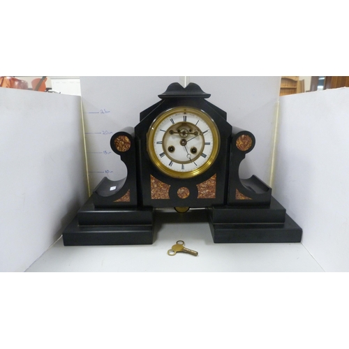 104 - Victorian black slate and marble mantel clock with twin train dial.