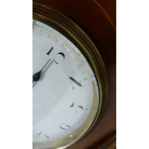 105 - Early 20th century inlaid mahogany mantel clock with brass columns.