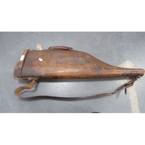 33 - Hide leg o'mutton gun case, initialled, with shoulder strap, and a bottle rack.  (2)