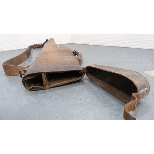 33 - Hide leg o'mutton gun case, initialled, with shoulder strap, and a bottle rack.  (2)