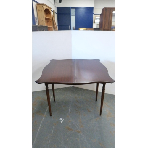 395 - Reproduction folding card table with serpentine tooled top.