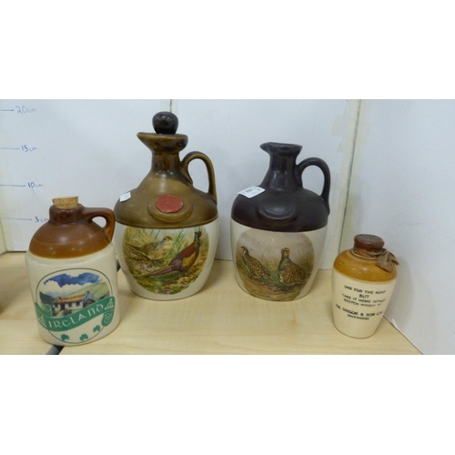 55 - Whisky flagons, stoneware storage jars and a blue and white teapot etc.