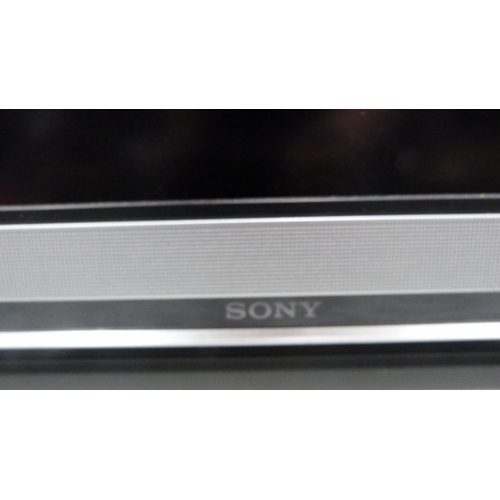 77 - Sony television and remote control.