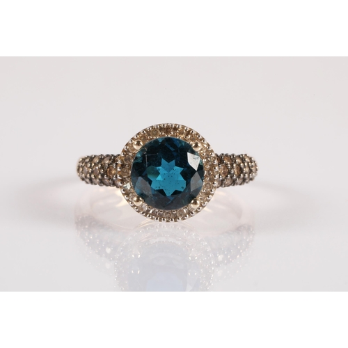 104 - 9ct gold ring set with a central blue gemstone, a halo of diamonds and champagne diamond shoulders, ... 