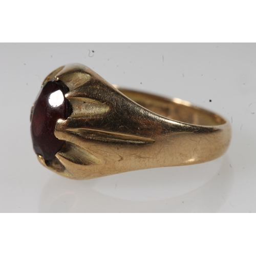 553 - 9ct gold faceted red stone set dress ring, 4.6g.