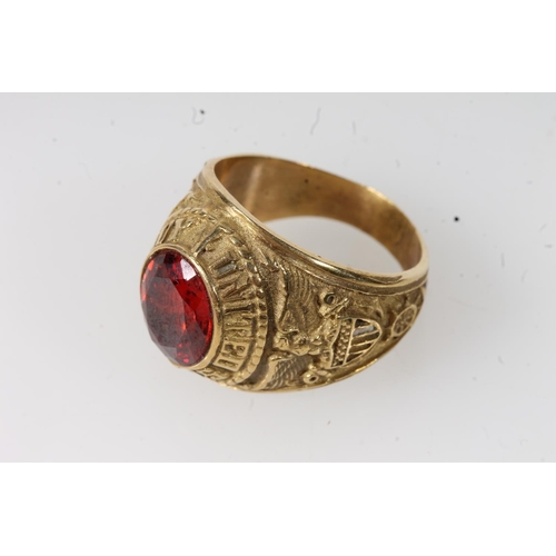 570 - Yellow metal United States Navy ring set with central red stone, stamped 10k. 