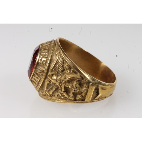 570 - Yellow metal United States Navy ring set with central red stone, stamped 10k. 