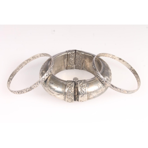 623 - Two Danecraft sterling silver bangles, 27g and a white metal bangle. 