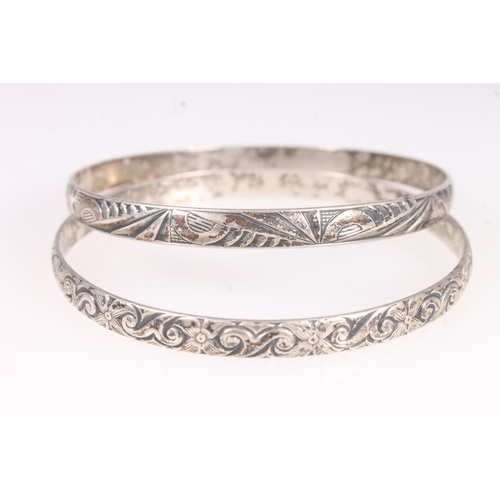 623 - Two Danecraft sterling silver bangles, 27g and a white metal bangle. 