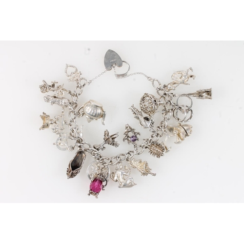 631 - Silver charm bracelet with dependant charms, 84g.