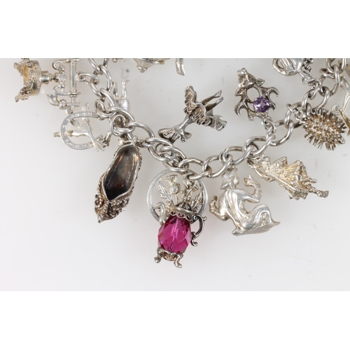 631 - Silver charm bracelet with dependant charms, 84g.