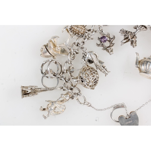 631 - Silver charm bracelet with dependant charms, 84g.