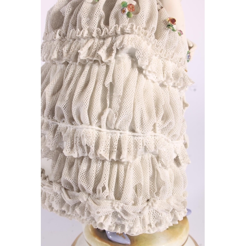 413 - German Volkstedt Dresden Lace porcelain figurine, early 20th century, of a debutante in frilled lace... 