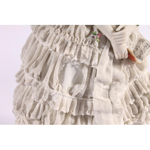 413 - German Volkstedt Dresden Lace porcelain figurine, early 20th century, of a debutante in frilled lace... 