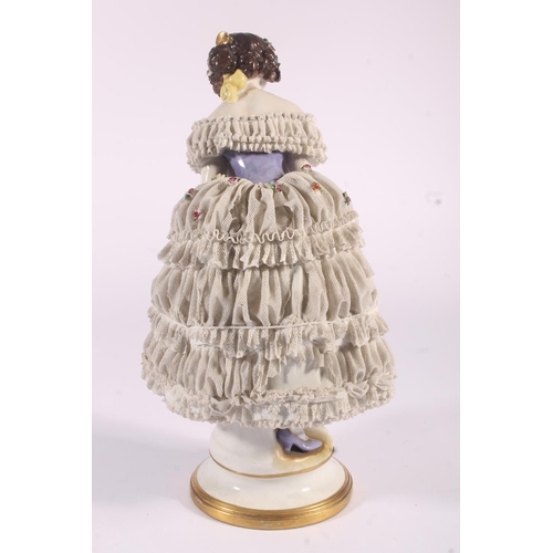 413 - German Volkstedt Dresden Lace porcelain figurine, early 20th century, of a debutante in frilled lace... 