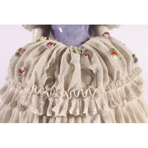 413 - German Volkstedt Dresden Lace porcelain figurine, early 20th century, of a debutante in frilled lace... 
