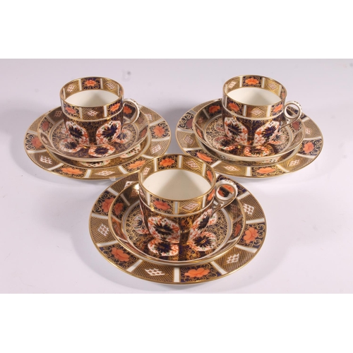 416 - Three Royal Crown Derby Imari 1128 pattern porcelain trios, of coffee cups, saucers and side plates,... 