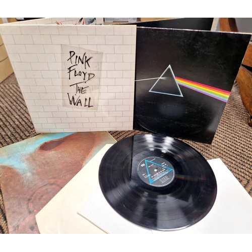 197 - Three Pink Floyd vinyl records, to include The Wall with sticker, Meddle, and Dark Side of the Moon ... 