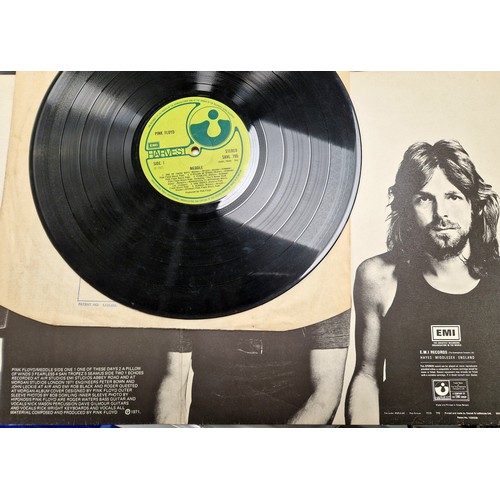 197 - Three Pink Floyd vinyl records, to include The Wall with sticker, Meddle, and Dark Side of the Moon ... 