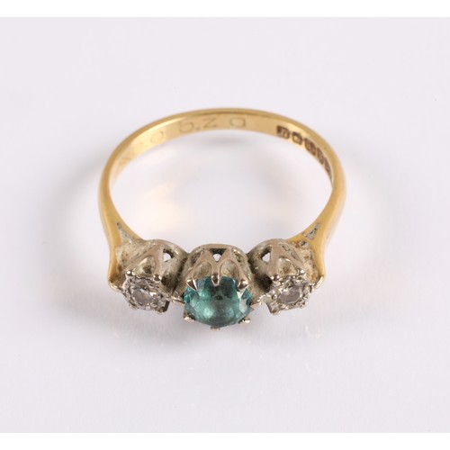 121 - 18ct gold ring set with a blue gemstone flanked by two diamonds in illusion settings, ring size O, 3... 