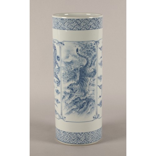 43 - Oriental blue and white cylindrical vase decorated with panels of animals, signed to base. 37cm