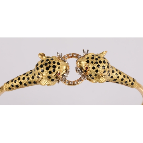 51 - 18k gold bangle in the form of two leopards grasping a ring, set with diamonds, rubies for eyes and ... 