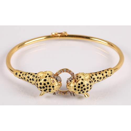 51 - 18k gold bangle in the form of two leopards grasping a ring, set with diamonds, rubies for eyes and ... 