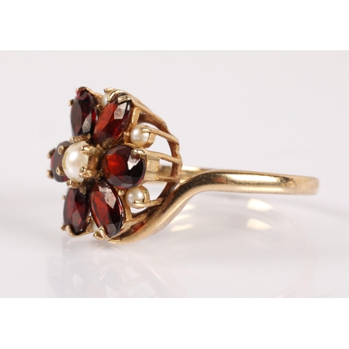 58 - 9ct gold ring set with garnets and simulated pearls in a flower design, ring size P, 3.9g