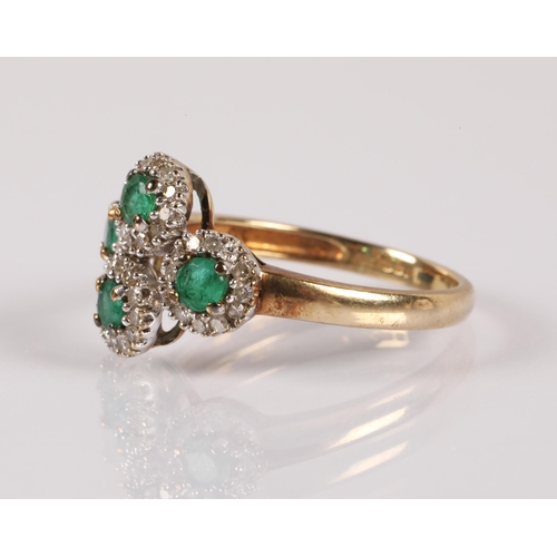 63 - 9ct gold ring set with emeralds surrounded by diamonds in four clusters, ring size K/L, 2g