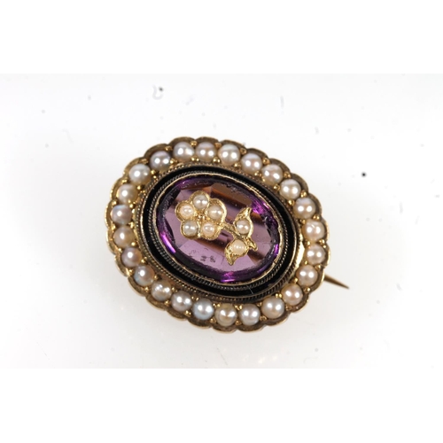 671 - Antique gold amethyst and seed pearl set brooch, the central stone set with floral pearl.