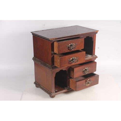 11 - Late 19th century four drawer cabinet with arched top compartments, 36cm high.