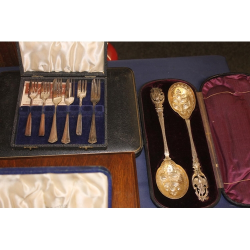 35 - Silver-plated cutlery to include a pair of late Victorian cast metal berry spoons with ornate pheasa... 