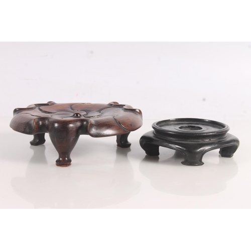 53 - Chinese carved wood lotus decorated stand and another Chinese wooden stand.