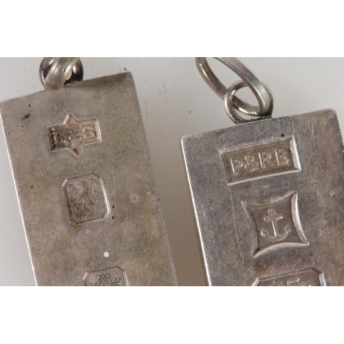 523 - Two silver ingot pendants 60g gross.