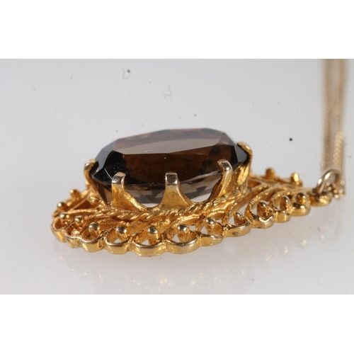 653 - 9ct gold mounted smoky quartz pendant on 9ct gold chain, 5.1g gross.