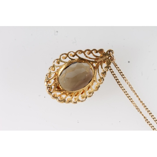 653 - 9ct gold mounted smoky quartz pendant on 9ct gold chain, 5.1g gross.